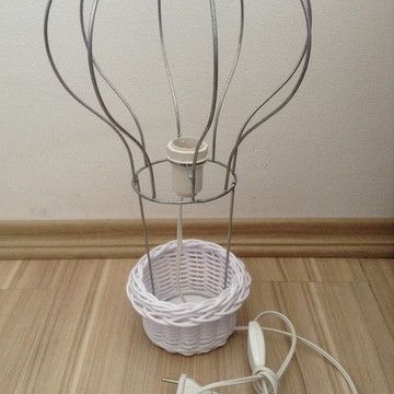 there is a wire basket with headphones on the floor next to an earbud