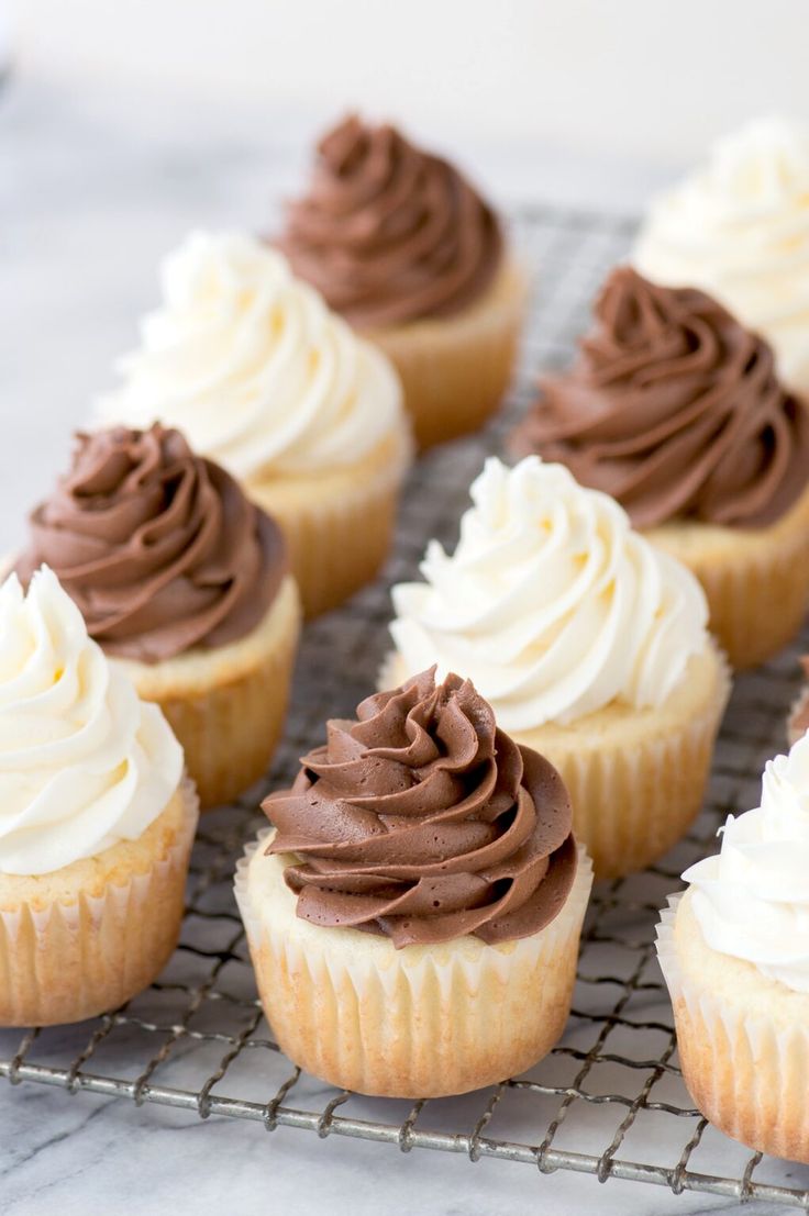 cupcakes with chocolate frosting sitting on a cooling rack