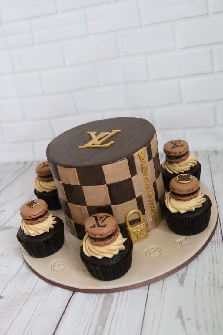 a cake with chocolate cupcakes in front of it