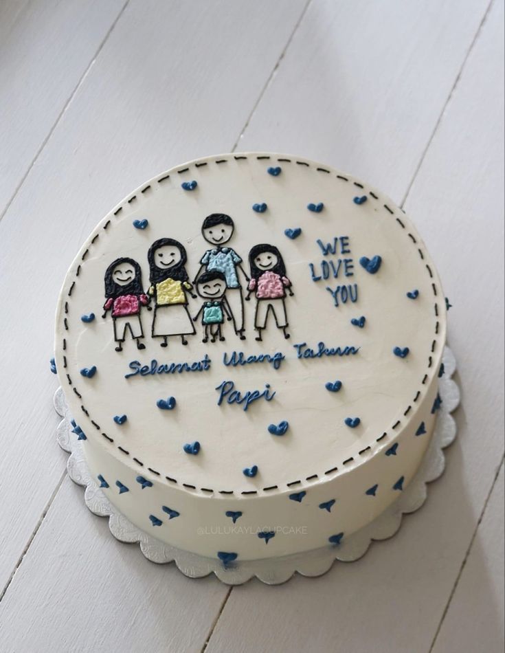 a white cake with blue hearts on it and the words we love you written on top