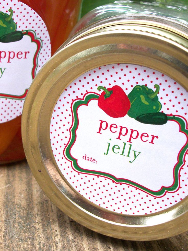 two jars filled with jam sitting on top of a table