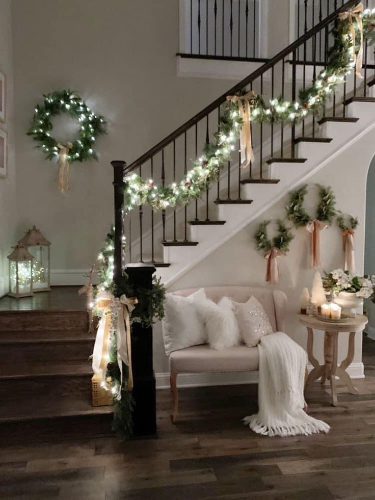 a living room filled with furniture and christmas lights on the wall next to a stair case