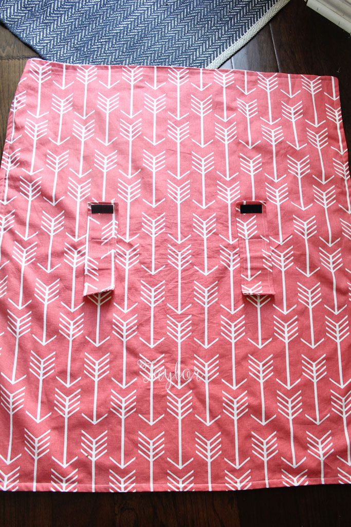 two pieces of fabric with arrows on them sitting on the floor next to each other