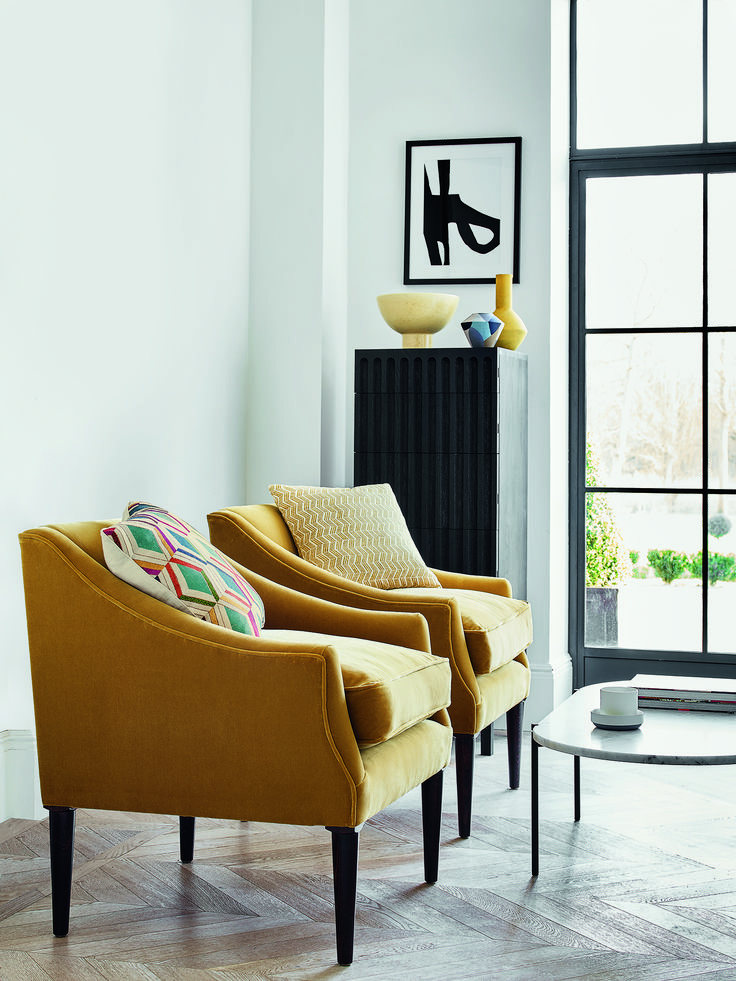 a living room with two chairs and a coffee table