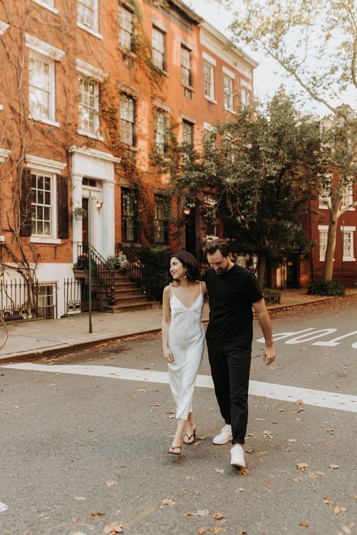 a man and woman are walking down the street