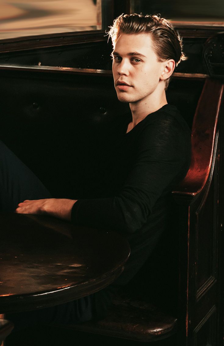 a young man sitting at a table in a restaurant