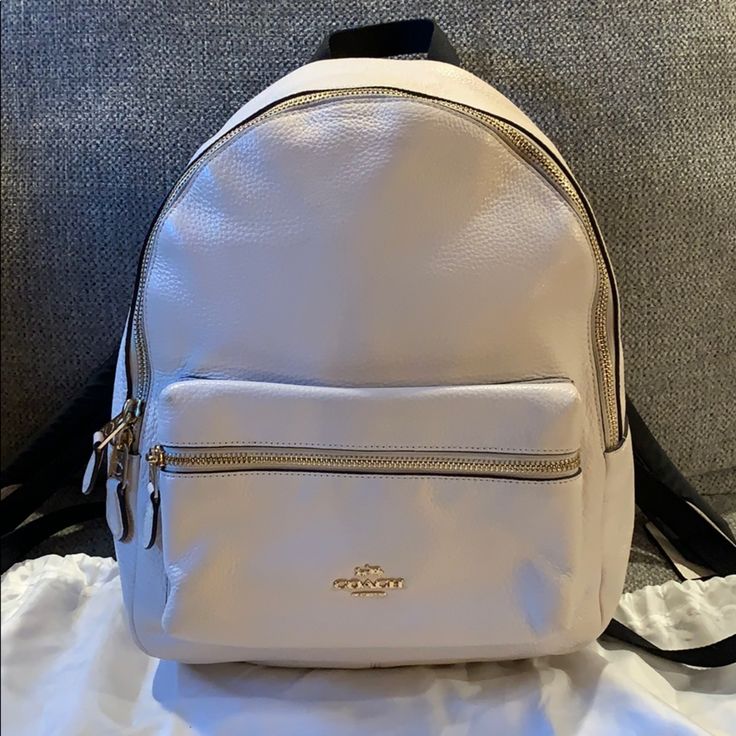 This Coach Backpack Is Absolutely Beautiful. It Has Only Been Used Less Than A Handful Of Times. The Interior And Exterior Are So Clean It Looks Brand New. The Straps Are Adjustable And So Comfortable. It Has The Main Compartment With A Zipper Inside. Then A Front Zipper Compartment As Well. The Interior Is A Dark Brown. The Exterior Is An Off White/Cream. It’s Beautiful White Standard Backpack For Errands, White Backpack For Errands, White Standard Backpack, Luxury White Leather Backpack With Adjustable Strap, Luxury White Standard Backpack, White Coach Backpack For Travel, White Standard Backpack For On-the-go, Luxury White Backpack With Detachable Strap, White Backpack With Detachable Strap For Errands