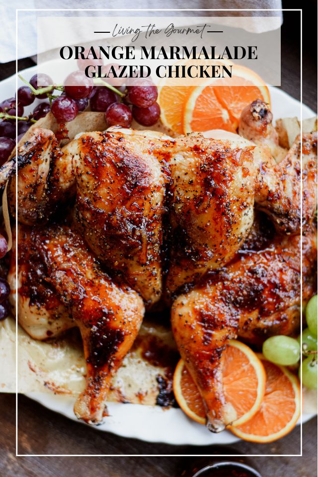 orange marmalade glazed chicken on a plate with grapes and oranges