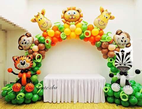 the balloon arch is decorated with animals and balloons