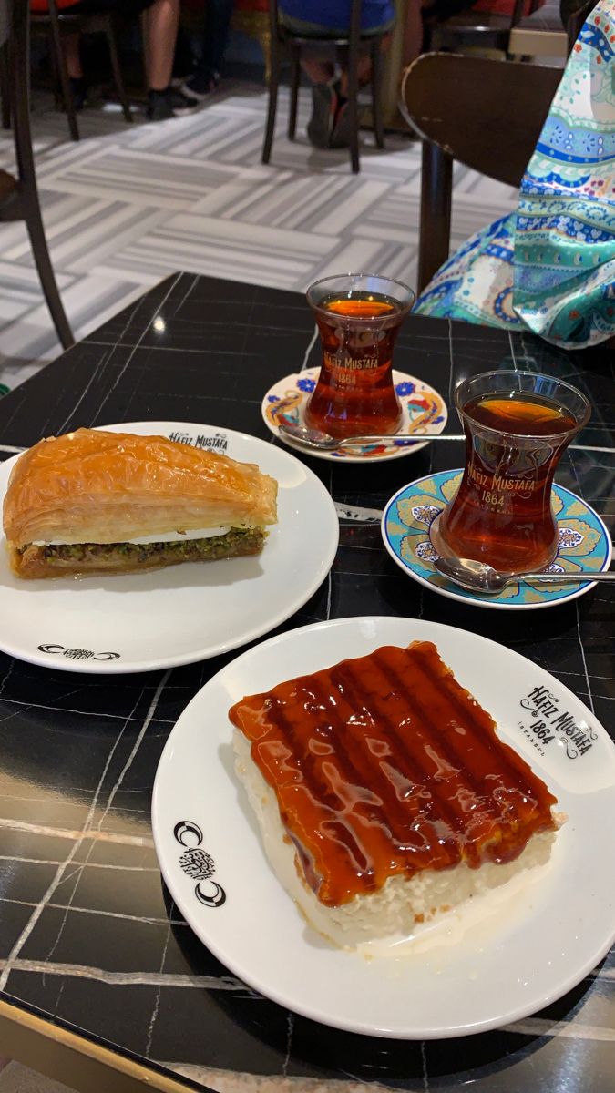 two plates with food on them sitting on a table