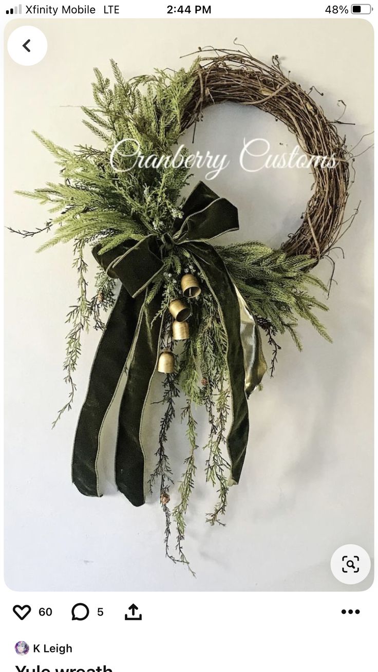 a christmas wreath with bells and greenery