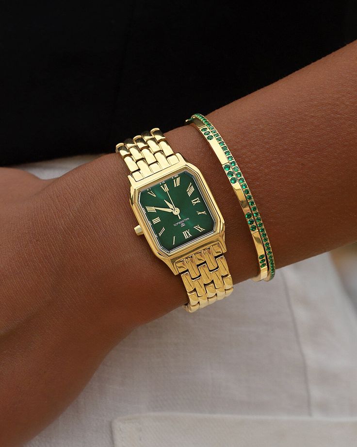 Case diameter: 22x26 mmCase thickness: 7 mmMaterial: 22k gold-plated 316L stainless steel Dial: Green sunray dial in brassIndex & hands: Polished stainless steelGlass: Diamond cut sapphire crystalMovement: Seiko VJ21Water Resistance: 3 ATMStrap: Solid strap in stainless steelStrap size: Onesize, fits all wristsLug width: 14 mmPackaging: Green presentation box with certificate and manualAvailability: In stock, Free and fast Shipping Worldwide Womens Dainty Watch, Green And Gold Bracelet Stack, Green And Gold Watch, Outfits With Watches Women, Styling Gold Jewelry, Women Accessories Ideas, Cool Jewelry Necklaces, Gold Women’s Watch, Clothes And Where To Buy Them