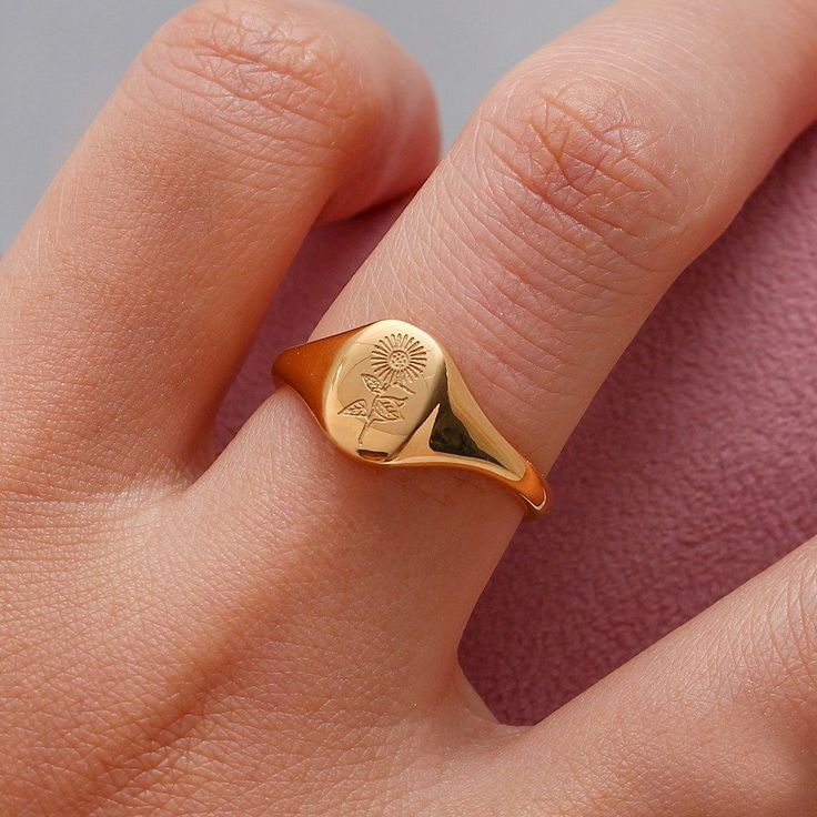 Give yourself the gift of flowers that won't wilt with the Floral Signet Ring! Pick the bloom that fits you best from wildflowers, lavender, laurel leaves, or a sunflower. Summer 2022 is calling and we got your back! DETAILS & SIZE Composition: 18K gold plated over 316L Stainless Steel Measurements: US ring sizes: 6, 7, 8 Waterproof, tarnish resistant, and nickel free Read about how to care for your jewelry here. Or shop Rings for more options! Lavender Sunflower, Jewelry Trending, Jewelry Casual, Trending Jewelry, Sunflower Ring, Lavender Tea, Flower Carving, Signet Rings, Tea Leaf