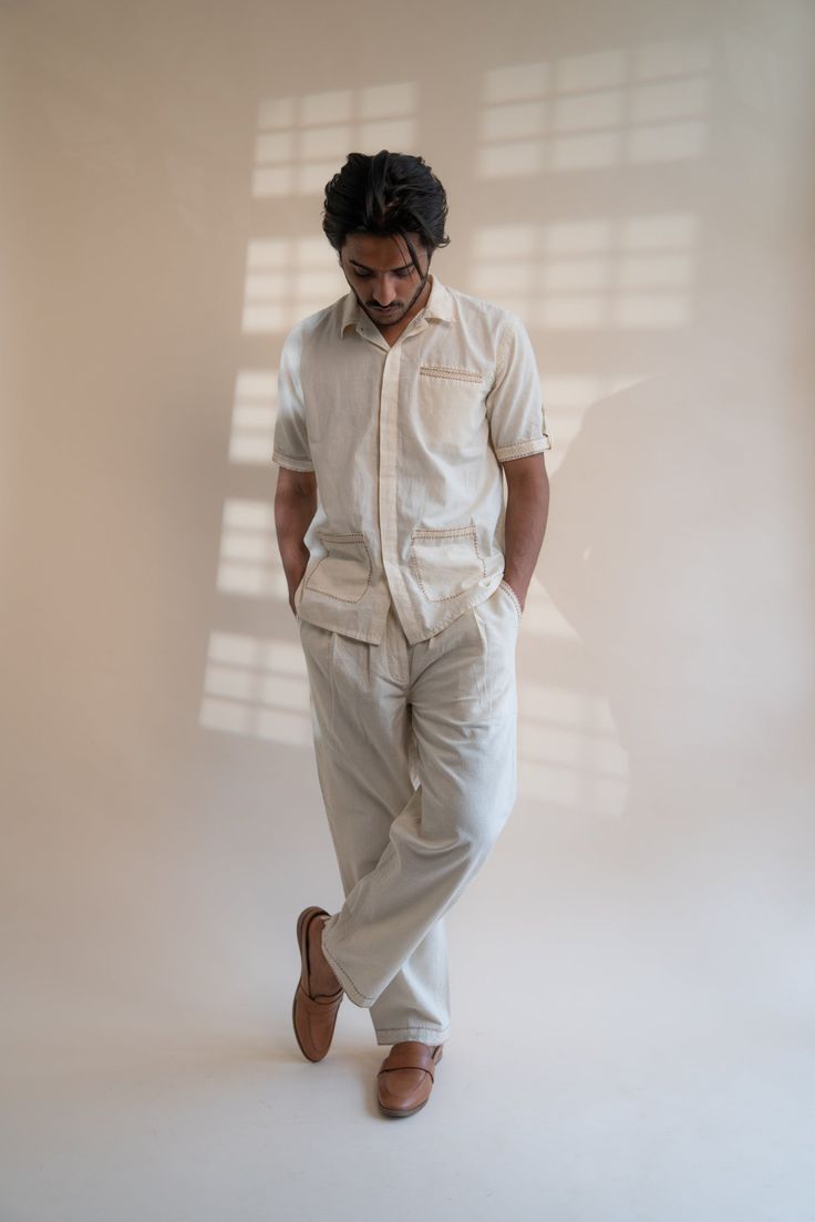 This Dawning Patch Pocket Shirt comes in a calm and soothing color. This 60s cotton shirt is undyed and unbleached. Replete with a spread collar, this half-sleeve shirt has an inverted pleat at the back and patch pockets in the front. The pockets and sleeve hems are embellished with Kantha, a form of Indian hand embroidery. *This item is a final sale and not eligible for returns or exchanges. *This item can take up to 14 business days to ship as it is made to order for you. White Short Sleeve Shirt With Patch Pockets, Classic Cotton Short Sleeve Shirt With Patch Pockets, Classic Beige Cotton Short Sleeve Shirt, Beige Cotton Short Sleeve Shirt With Pockets, Beige Cotton Buttoned Camp Shirt, Beige Cotton Tops With Welt Pockets, Classic Cotton Camp Shirt With Patch Pockets, Beige Cotton Camp Shirt With Relaxed Fit, Beige Relaxed Fit Camp Shirt With Pockets