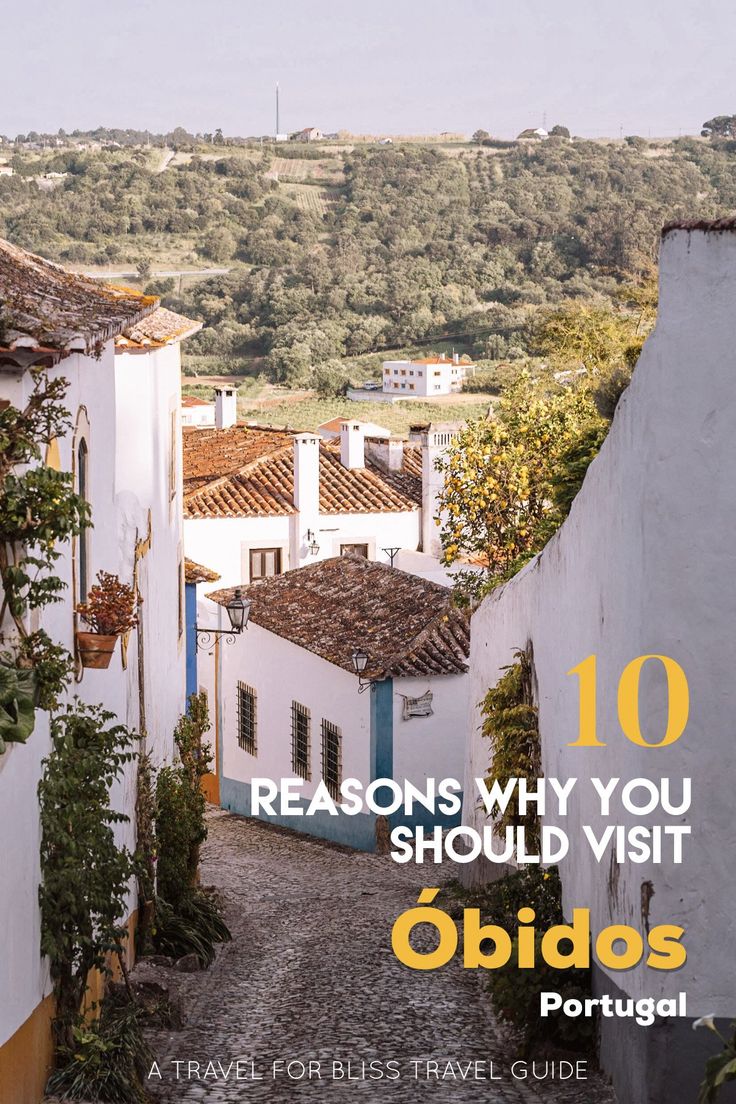 an alley way with the words 10 reasons why you should visit obidas portugal