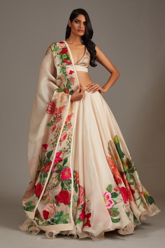 Ivory flared lehenga in organza base with botanical floral print and sequin highlights. Paired with sleeveless plunging V neckline blouse with all over sequin encrustments and printed dupatta.
Components: 3
Pattern: Print 
Type Of Work: Botanical Floral
Neckline: Plunging V Neck
Sleeve Type: Sleeveless
Fabric: Organza, Lining: Cotton
Color: Ivory
Other Details: 
Note: The cancan skirt worn by the model is not for sale
Occasion: Bride, Destination Wedding - Aza Fashions Organza Floral Lehenga, Christmas Outfit Casual, Lehenga Pattern, Desi Dress, Raw Silk Lehenga, Wedding Lehenga Designs, Gaun Fashion, Rohit Bal, Lehenga Style