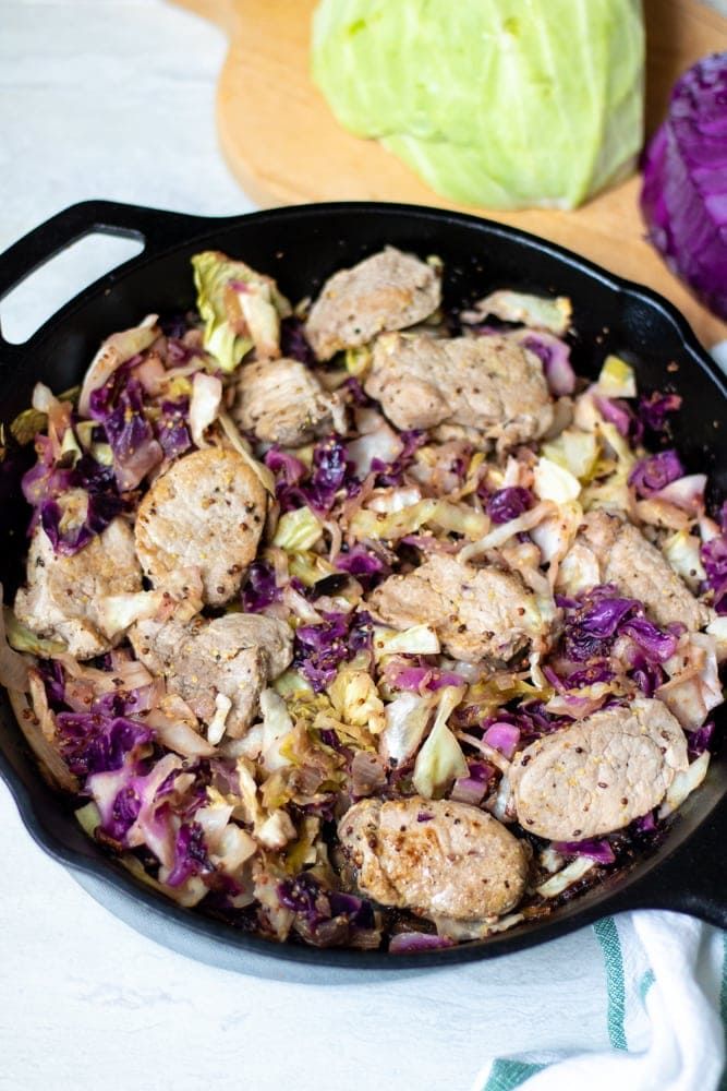 a skillet filled with meat and cabbage