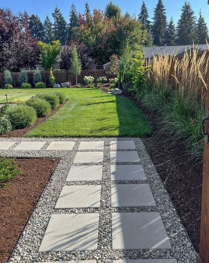 a stone walkway in the middle of a garden