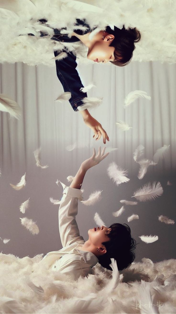 two people are in the air surrounded by white feathers