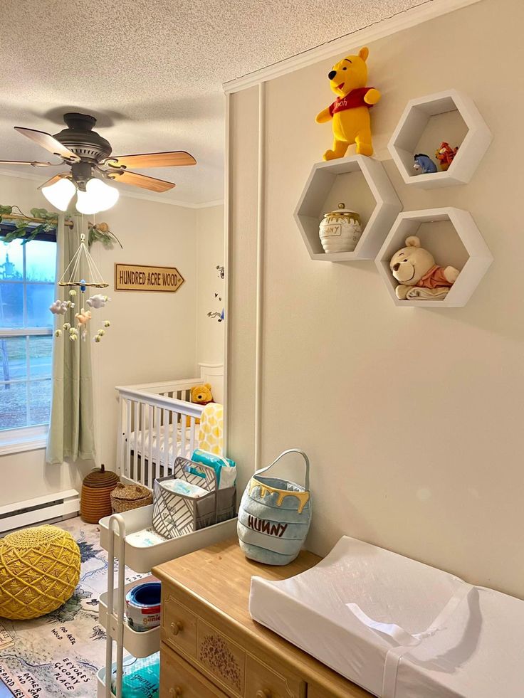 a baby's room with winnie the pooh decorations