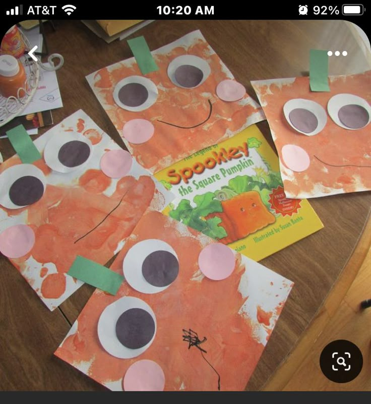 some paper bags that have been made to look like oranges and carrots with googly eyes