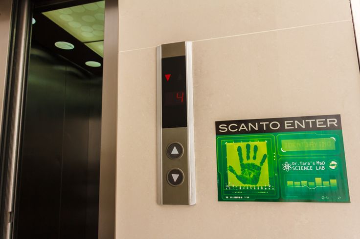 an exit door with a hand print on it and a sign that says sanito enter