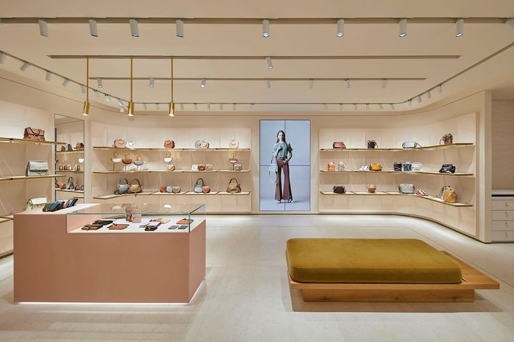 the inside of a women's clothing store with lots of shelves