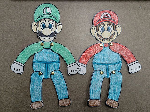 two paper cut outs of mario and luigi