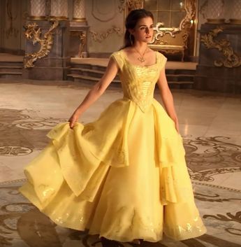 a woman in a yellow dress standing on the floor