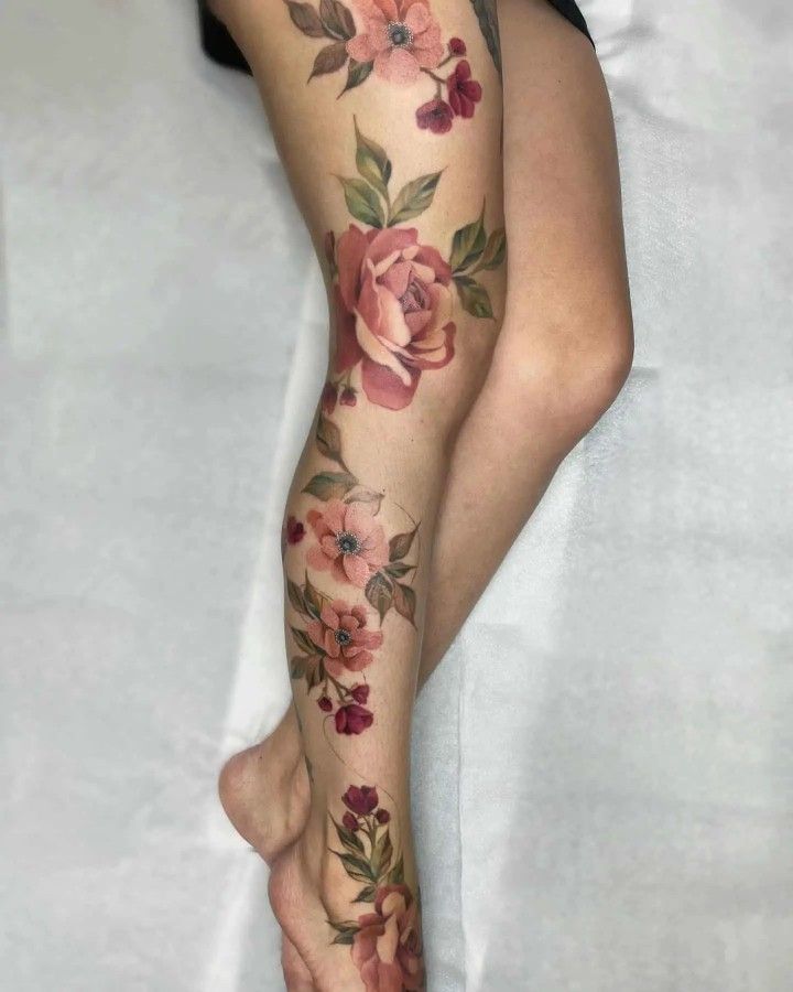 a woman's leg with flowers on it