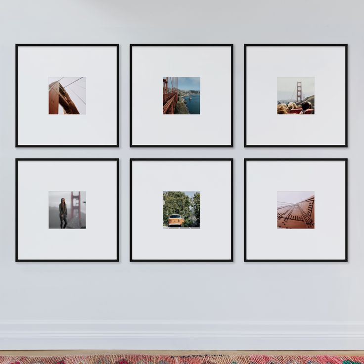 four black and white photos hanging on the wall above a rug with a red chair