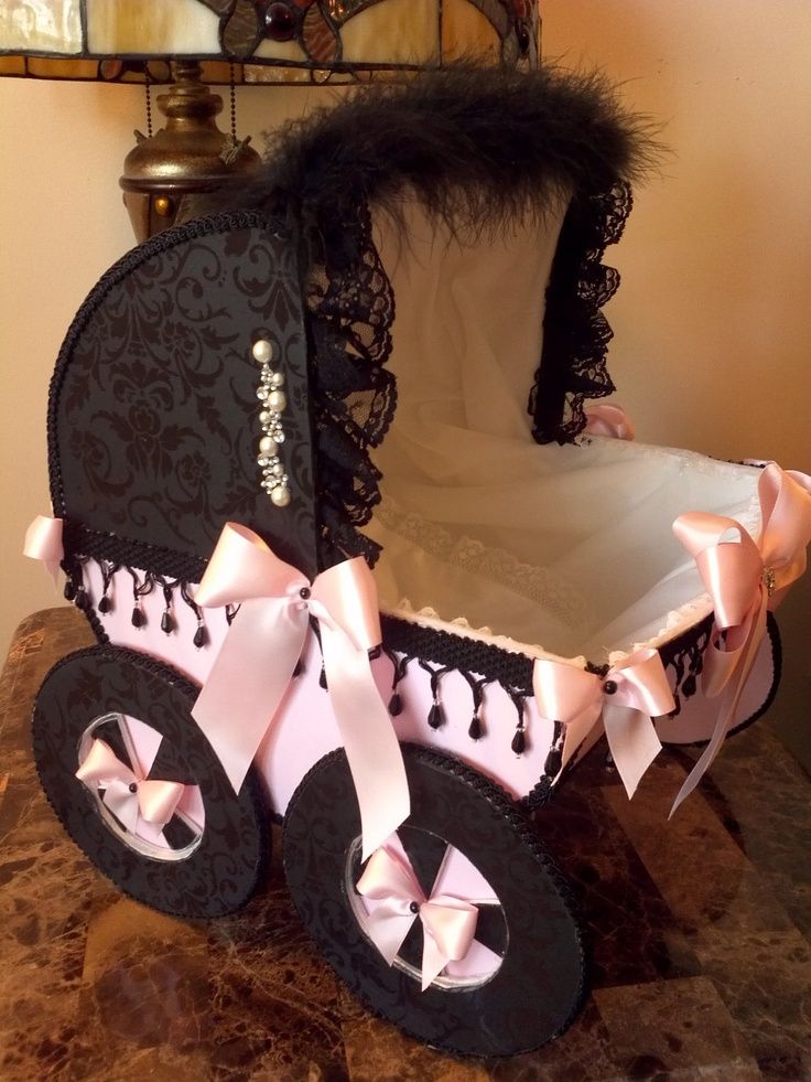 a black and pink baby carriage sitting on top of a table