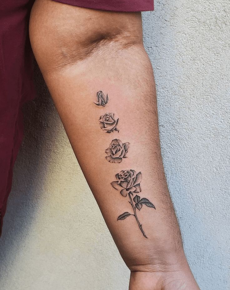 a person with a rose tattoo on their arm