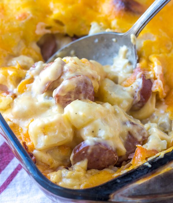 a casserole dish with sausage and cheese in it is ready to be eaten