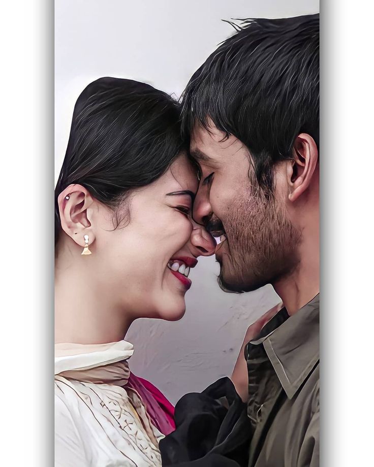 a man and woman smiling at each other with their faces close to the foreheads