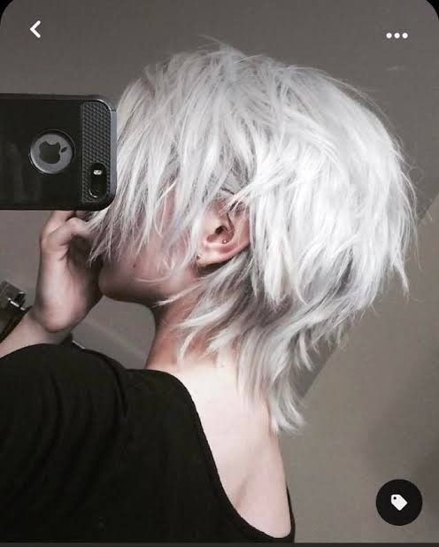 a woman with white hair is taking a selfie in front of a mirror while holding her cell phone up to her ear