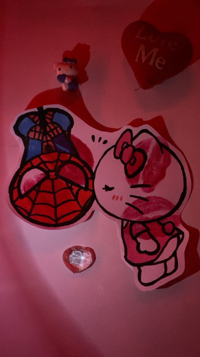 some stickers and hearts on a pink surface with the image of a cat in a spider - man suit