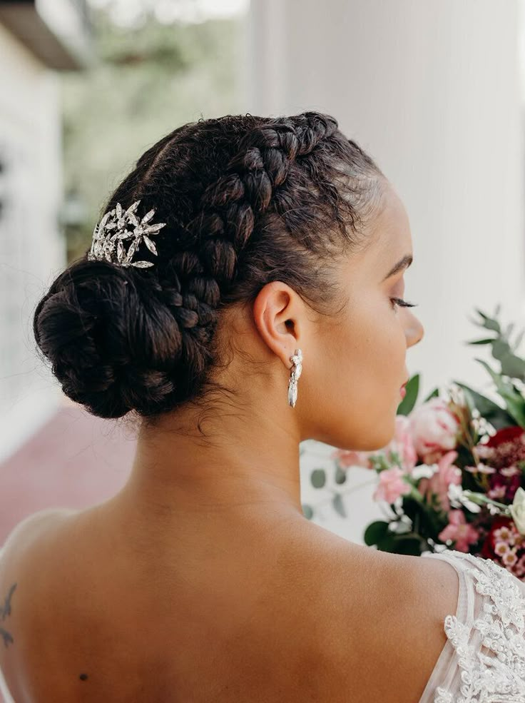 a woman wearing a wedding dress and holding flowers in her hand, looking off to the side