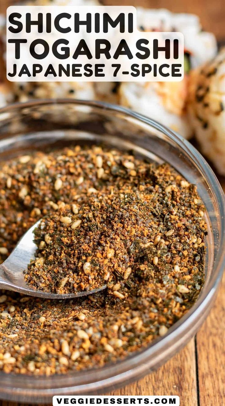 a spoon full of spices on top of a wooden table with the words, shichimi togarashi japanese 7 - spice