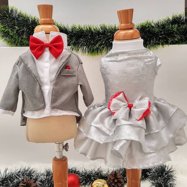 two mannequins dressed up as children's clothes on display in front of christmas decorations