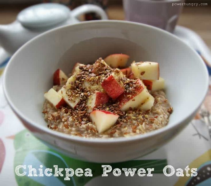 a bowl filled with oatmeal topped with sliced apples