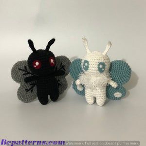 two crocheted stuffed animals sitting next to each other