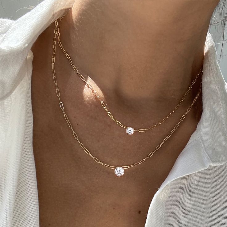 A twist on a classic, our Charo necklace features a choice of two different sized round diamonds secured in a 4 prong setting. A classic piece you will cherish for a lifetime. This necklace can be dressed up or down, layered with our Herringbone Chain Necklace , or worn by itself. – Made in 18k solid gold with a high-quality ethically sourced diamond. – Handpicked G-H/SI Round Brilliant Diamond, carat weight 0.50 – Choice of adjustable chain length, 16 and 18 inches. – Handcrafted just for you i Timeless Diamond White Necklace With Prong Setting, Dazzling Single Diamond Wedding Necklace, Classic Diamond Necklace With Round Clavicle Chain Pendant, Timeless Necklace With Prong Setting In Round Pendant, Elegant Chain Necklace With Brilliant Cut, Elegant Double Strand Diamond Necklaces, Elegant Double Strand Diamond Necklace, Minimalist Vvs Clarity Round Stone Jewelry, Dazzling Ethical Diamond Round Pendant Necklace