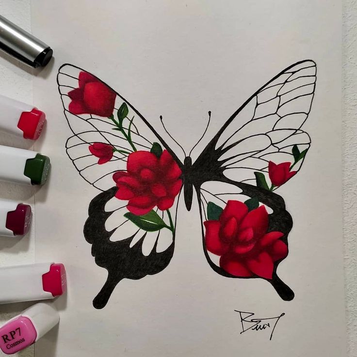 a drawing of a butterfly with red roses on it's wings and two markers