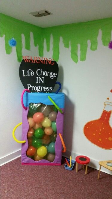 there is a bag full of balls in front of a wall with the words life change in progress on it