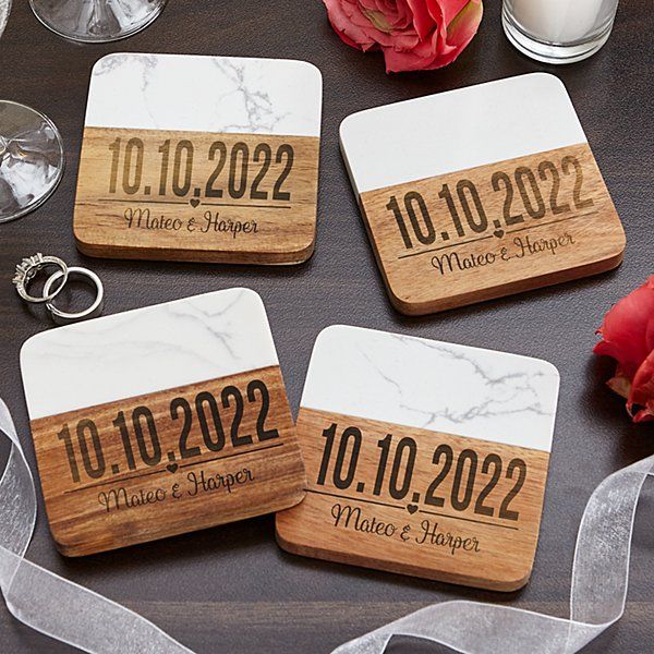 four wooden coasters with wedding date printed on them