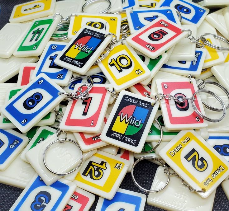 a bunch of key chains that are all different colors and shapes with numbers on them