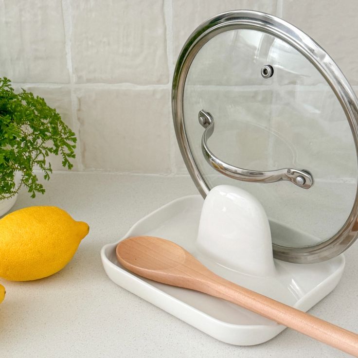 there is a mirror and some lemons on the counter next to eachother