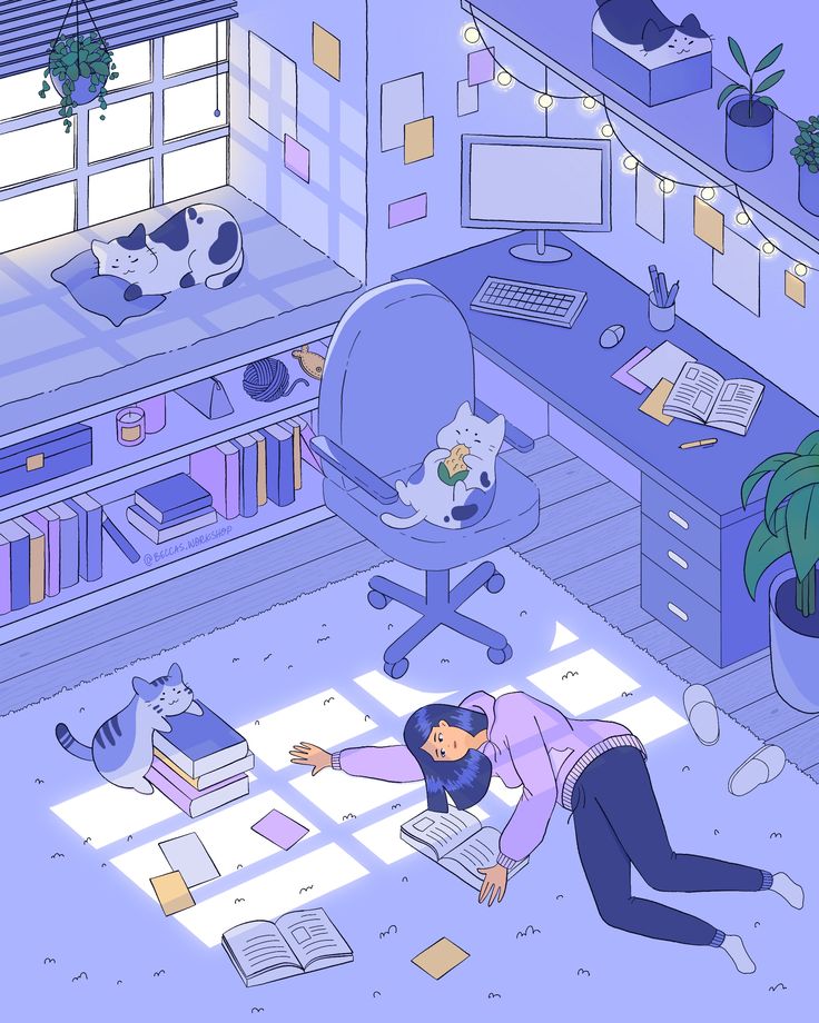 a woman laying on the floor in front of a computer desk with cats and books