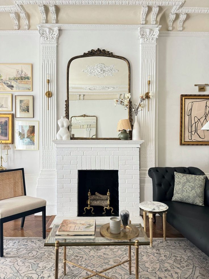 a living room filled with furniture and a fire place in front of a white fireplace